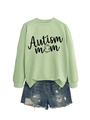 Flat lay of an Autism Mom light green sweatshirt with denim shorts on white background - Olive Green (Black Font)