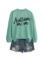 Detail of mint green Autism Mom sweatshirt with puzzle icon and comfortable cotton fabric - Light Green (Black Text)