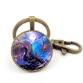 Blauwe draak glazen sleutelhanger met bronzen karabijnsluiting en sterrenhemel achtergrond - Brons Stijl 2
