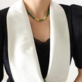 Luxurious gold necklace featuring square emerald green zircons on a model's neck - 39cm / Green Necklace