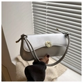 Detail of silver matte flap bag featuring a golden spiral round clasp and knot handle - Silver