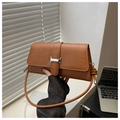 Detailed view of brown crocodile texture and silver H-buckle on vintage shoulder bag - Brown