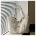 Detail of cream corduroy tote bag showing vertical texture and Fashion Instinct label - White