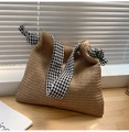 Detail of hand-woven straw tote bag featuring stylish houndstooth patterned wide straps - Brown