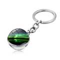 Detail of silver aurora keychain with glass cabochon showing green northern lights landscape - Aurora High Contrast Style (XSWX1934-9)