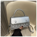 Detailed close-up of a silver metallic crossbody bag with textured checkered patterns - Silver