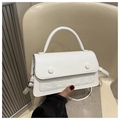 Macro detail of white faux leather crossbody bag with embossed checkerboard pattern - White