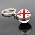 Detail of Georgia flag keychain with a glass dome pendant and silver metal ring - Georgia