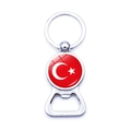 Close-up of a silver metal bottle opener keychain with circular Turkey flag emblem - Turkey