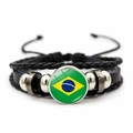 Close-up of multilayer leather bracelet with Brazil flag metal charm and metal rings - Brazil