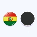 Detail of Bolivia flag glass fridge magnet showing the front emblem and magnetic back side - Bolivia