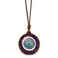 Macro shot of evil eye wood pendant with vintage cloud carving and brown wax cord - Spiral Wood Evil Eye (JY009130-8)