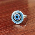 Macro shot of silver adjustable evil eye ring with blue concentric patterns on wood - Bohemian Gold Pupil Evil Eye Style (JY009127-12)