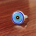 Macro shot of silver evil eye ring featuring blue concentric circles on wooden texture - Brown Concentric Exotic Evil Eye Style (JY009127-9)
