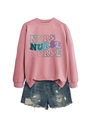 Detail of dusty pink nurse sweatshirt with colorful layered text and denim shorts - S / Rose Gold