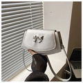 Detail of silver fan-shaped crossbody bag with metal bow decoration and leather strap - Silver