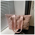 Detail view of pink quilted tote bag showing diamond stitching and cloud-shaped leather patch - Pink