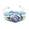 Vista de detalle de pulsera de cuero trenzado azul con amuleto central de Ojo Turco - Modelo Azul 7