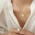 French luxury gold necklace with oval shell pendant and matching pearl ring on model - Gold-8602