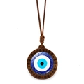 Ethnic wood evil eye necklace featuring a blue glass eye pendant on brown cord - Spiral Wood Evil Eye (JY009130-2)