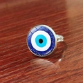 Silver adjustable evil eye ring with blue glitter finish on a wooden background - Deep Blue Glitter Evil Eye Style (JY009127-2)