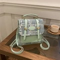 British style mint green backpack with geometric patterns and top handle on a wooden table - No Pendant / Green