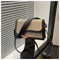 Detail of woven crossbody bag featuring black leather trim and wavy flap design - Black
