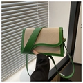 Detail of canvas crossbody bag featuring green leather trim and wave-shaped flap design - Green