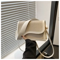 Detail of a beige woven shoulder bag with wavy white leather trim and adjustable strap - White