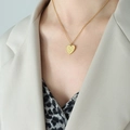 Gold heart pendant necklace with engraved YES NO MAYBE text worn on neck model - Gold Heart (40+5cm)