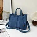 Blue corduroy tote bag with dual pockets and adjustable strap in a minimalist setting - Blue