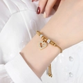 Adjustable gold plated heart bracelet featuring sparkling pavé crystals and slider clasp - Gold
