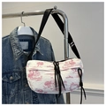Detail of red toile de jouy pattern on crinkled nylon fabric with black adjustable strap - Pink