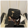 Detail of black quilted leather shoulder bag with gold deer charm and wide letter strap - Black