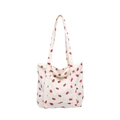 White corduroy tote bag featuring red strawberry prints and minimalist shoulder straps - White