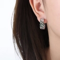 Silver hollow mesh C-shape earrings with emerald green crystals on model - Silver With Green Cubic Zirconia (F942)