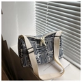 Macro view of blue canvas tote bag featuring white geometric stripes and double zipper pullers - Blue