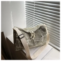 Close-up of olive green and beige woven tote bag with abstract patterns and zipper - Yellow