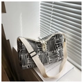 Detail of striped canvas tote bag showing wide shoulder strap and knot zipper pulls - Black