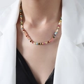 Colorful tourmaline beaded necklace with golden hexagonal spacers worn by model - Colorful Tourmaline Faceted Stone Necklace