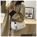 Detail of white cylindrical canvas crossbody bag with wide geometric woven shoulder strap - White and Black