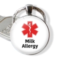 Macro detail of round medical alert keychain with red star and Milk Allergy text - Milk Allergy