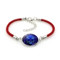 Detail of red braided zodiac bracelet featuring a Leo symbol and silver lobster clasp - Leo (5Leo) / Red