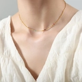 Minimalist gold titanium necklace with colorful beads on a model's collarbone - 40+5cm / Gold with Multi-color Beads