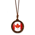 Detailed view of round wooden Canada maple leaf pendant with spiral carvings and brown cord - Maple Leaf With Overprinted Star Style (JY009151-6)