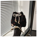 Detail of black corduroy bucket bag with strawberry embroidery and white drawstring closure - Black Strawberry