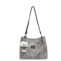 Gray canvas tote bag with black straps and a white plush cloud charm on plain background - Gray
