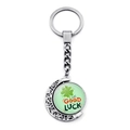 Detail showing the rotating green four-leaf clover pendant on a silver keychain with moon motif - Orange Black Lucky Style (JY009293-10)