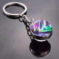 Macro detail of aurora borealis glass ball keychain featuring snowy forest night sky - Brilliant Purple Green Aurora Style (JY009320-9)