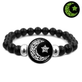 Detailed view of luminous sun and moon beaded bracelet with glowing green effect - Moon